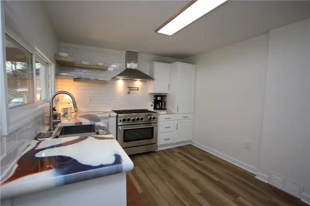 a kitchen with a sink and a stove top oven