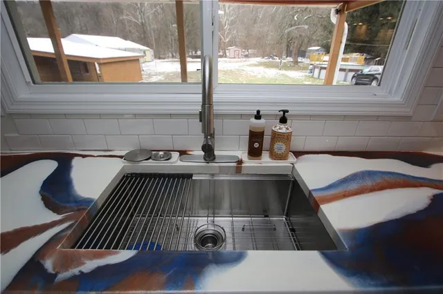 a kitchen with a stove and white cabinets