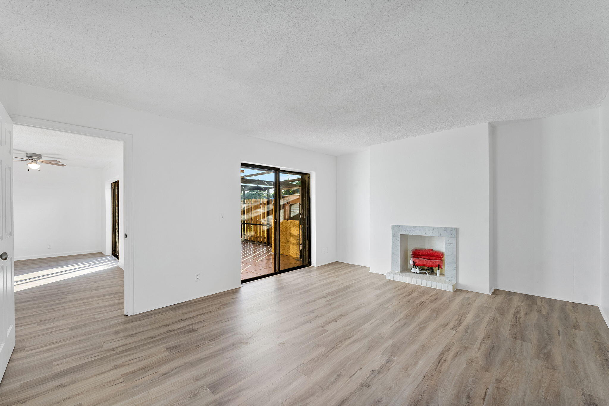291 Woodland Road Palm Springs, FL 33461 - Photo 13 of 32 a view of an empty room with a fireplace and a window