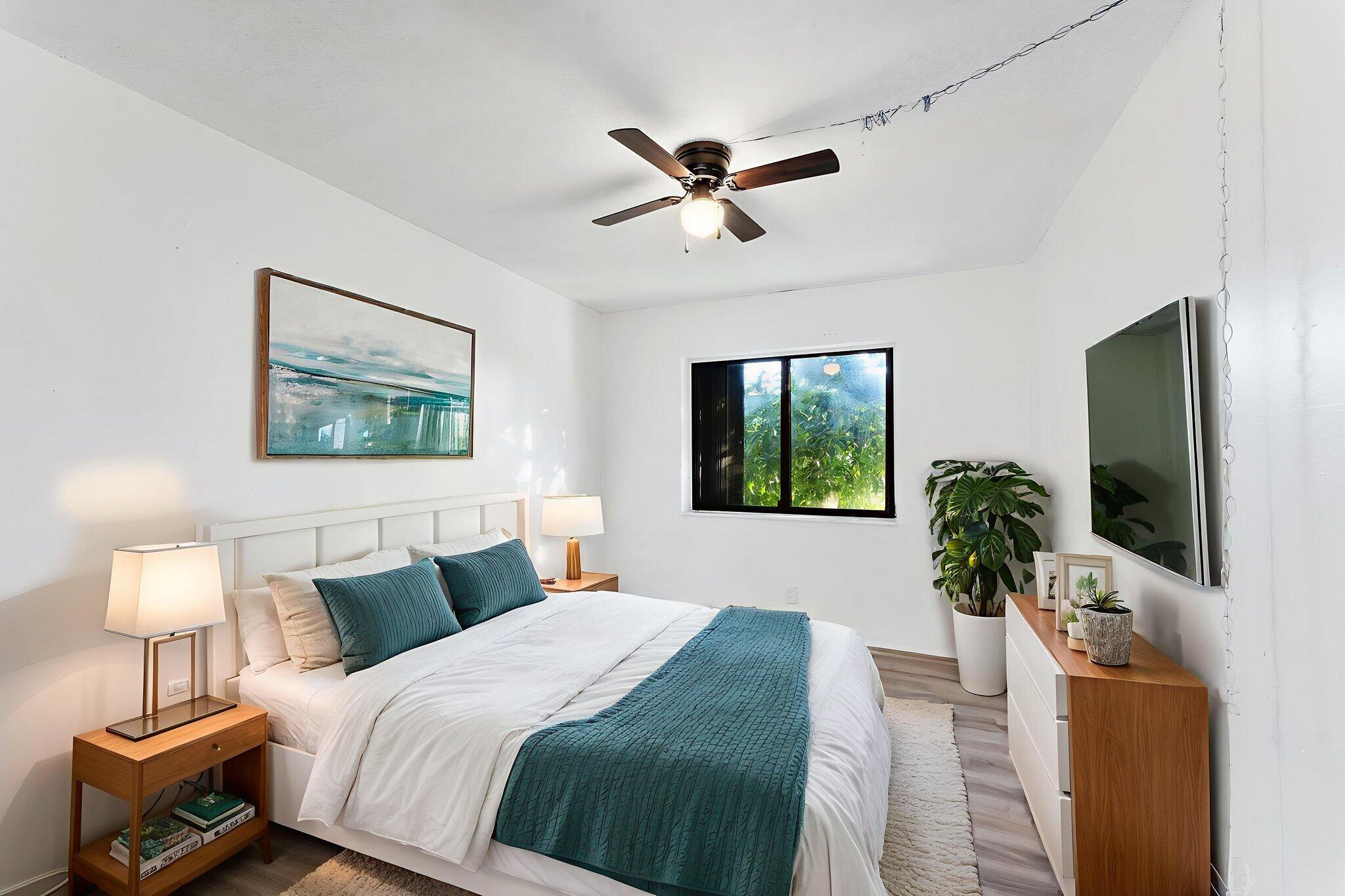 291 Woodland Road Palm Springs, FL 33461 - Photo 20 of 32 a bedroom with a bed and a flat screen tv