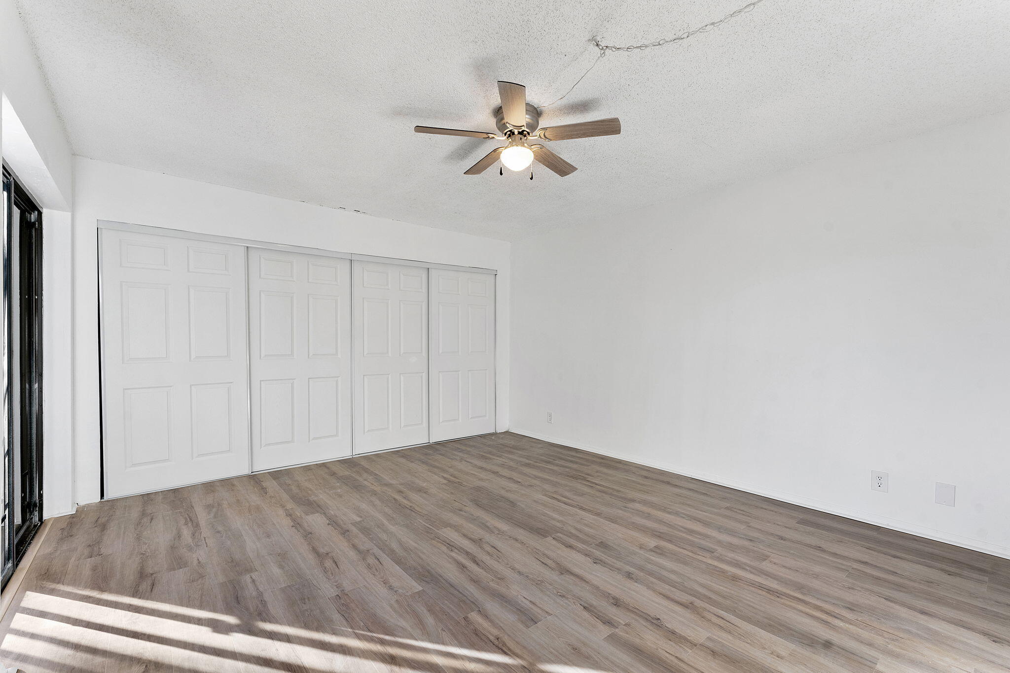 291 Woodland Road Palm Springs, FL 33461 - Photo 24 of 32 a view of empty room with wooden floor