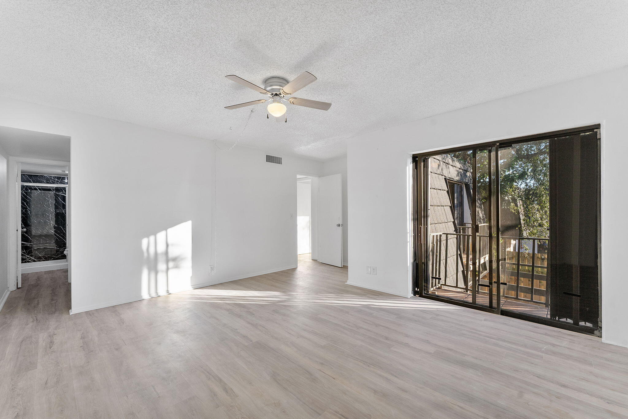291 Woodland Road Palm Springs, FL 33461 - Photo 26 of 32 wooden floor in an empty room with a window