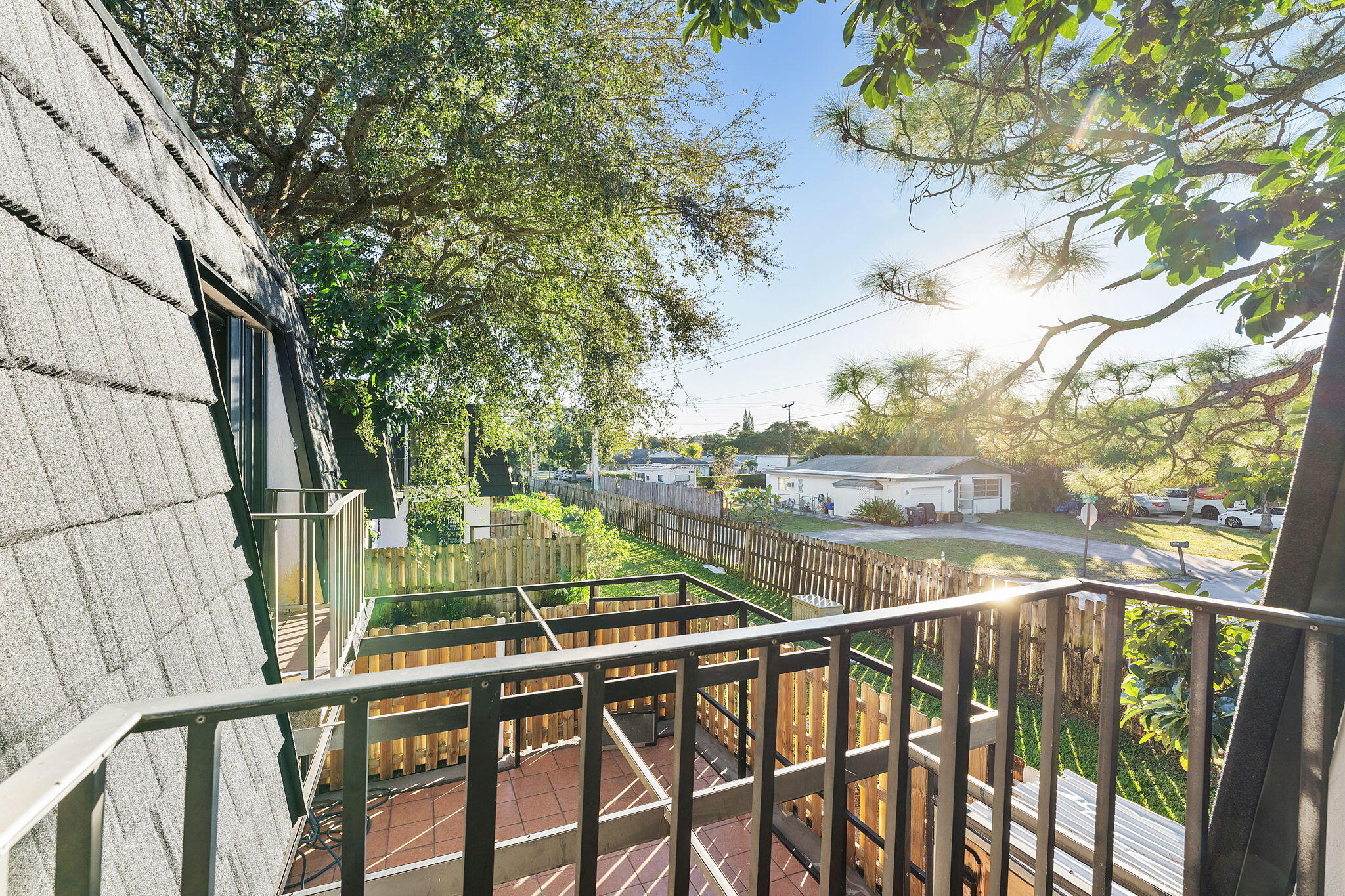 291 Woodland Road Palm Springs, FL 33461 - Photo 27 of 32 a view of balcony with wooden floor and fence