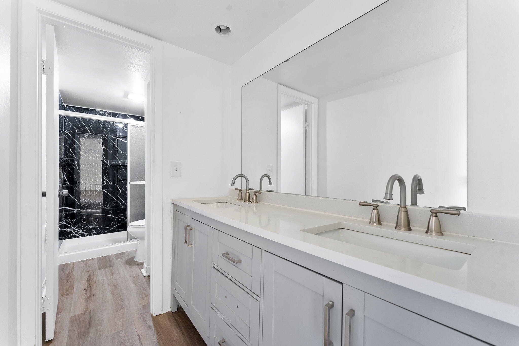 291 Woodland Road Palm Springs, FL 33461 - Photo 28 of 32 a bathroom with a sink and a mirror