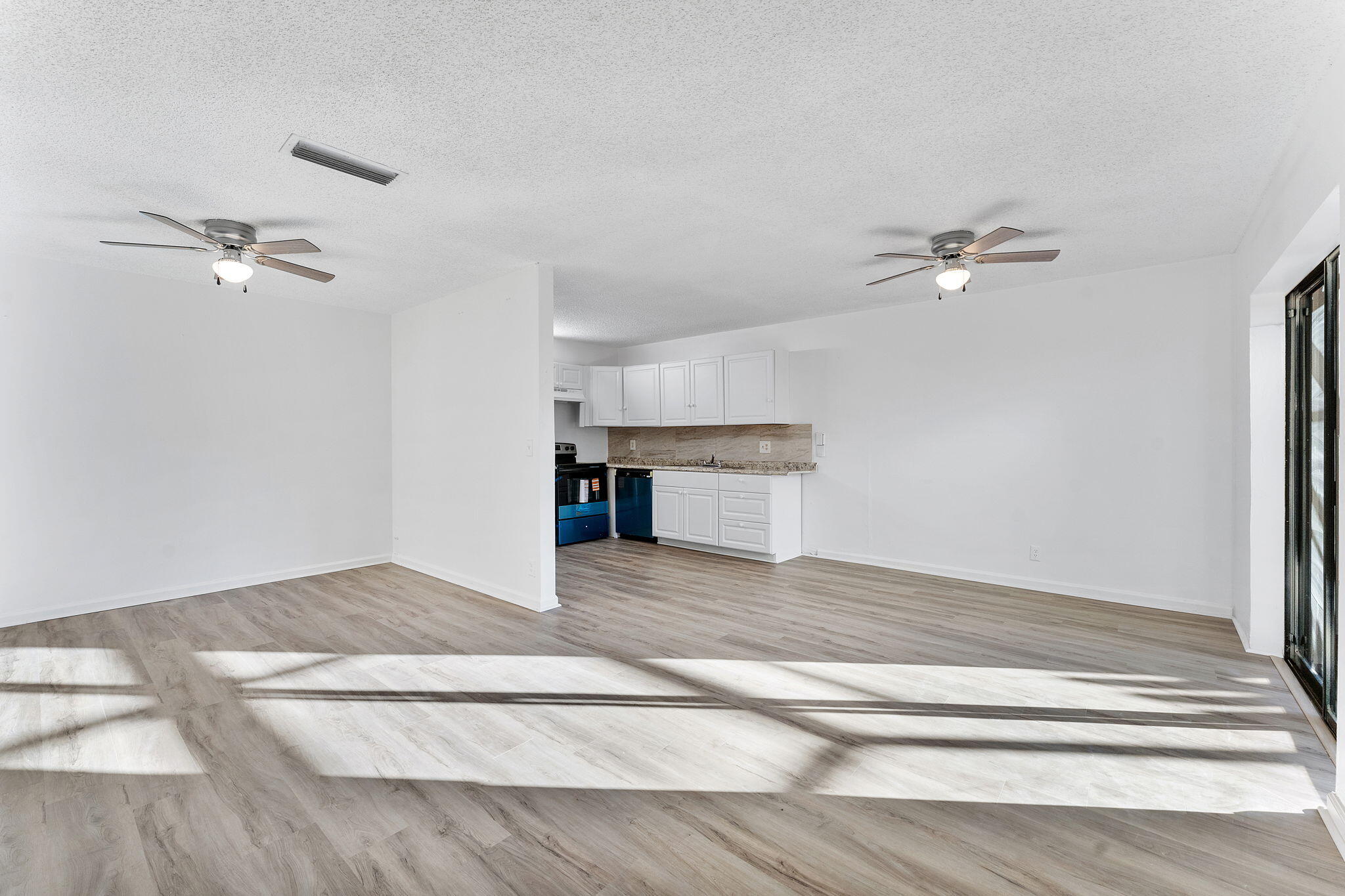 291 Woodland Road Palm Springs, FL 33461 - Photo 3 of 32 a view of an empty room with a chandelier fan
