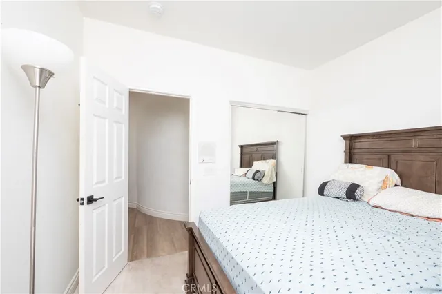 a bedroom with a large bed and a fireplace