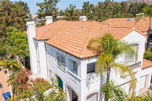 a view of a house with swimming pool and sitting area