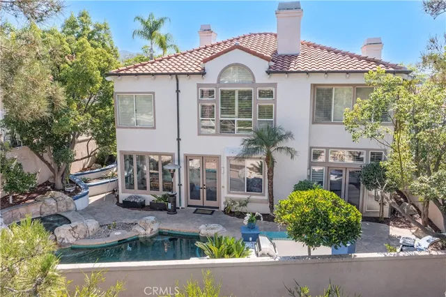 a living room with furniture gym equipment and large windows