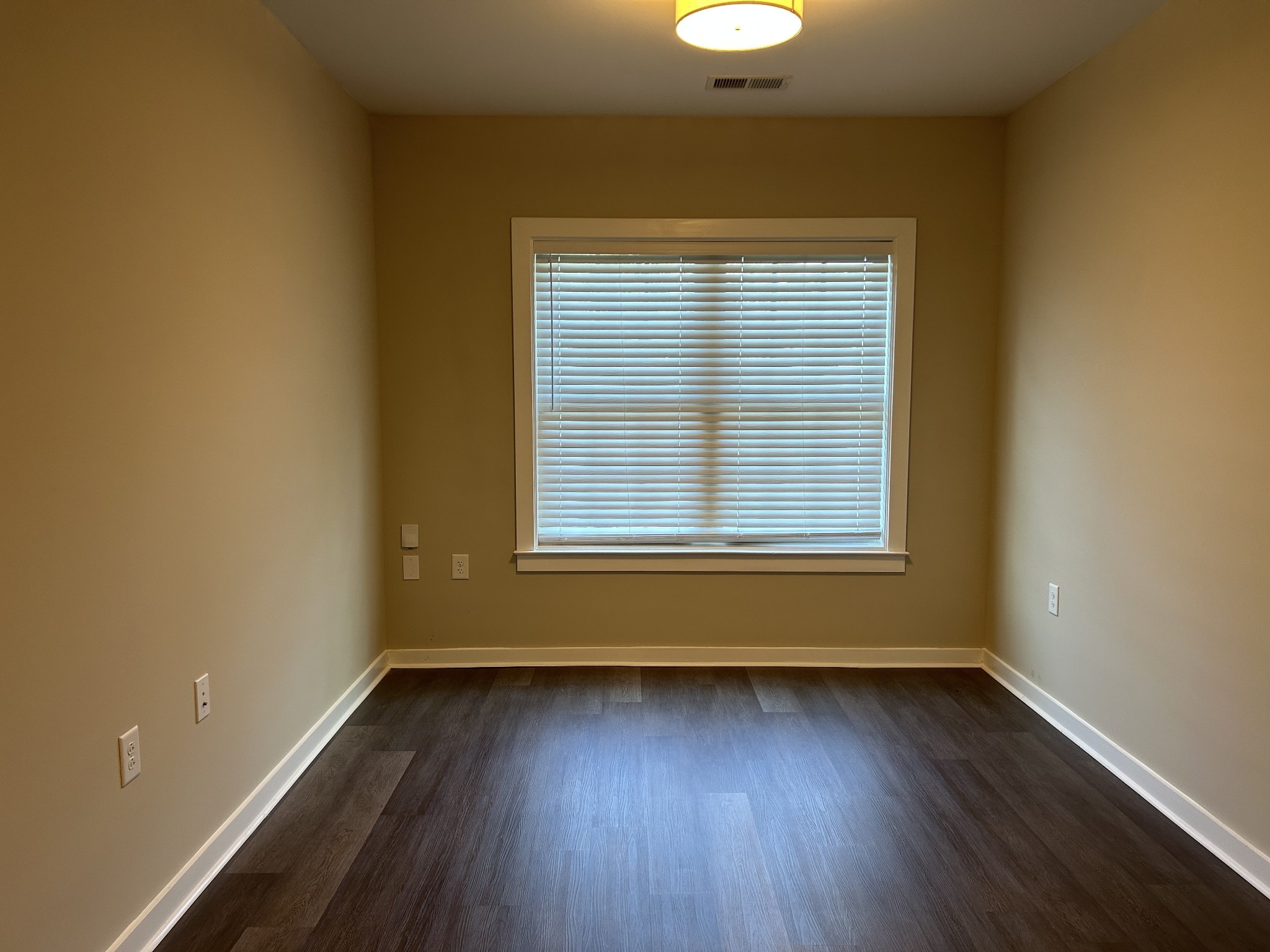 1319 West Main Street, Unit 108 Franklin, TN 37064 - Photo 8 of 25 an empty room with wooden floor and windows