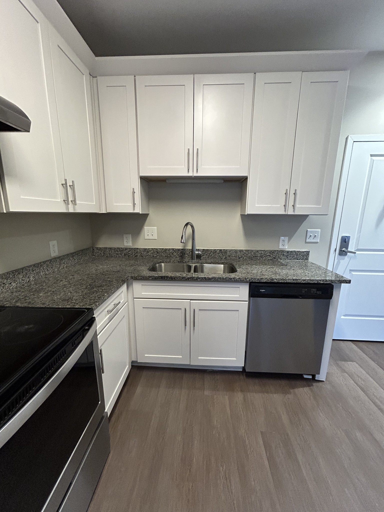 1319 West Main Street, Unit 108 Franklin, TN 37064 - Photo 9 of 25 a white kitchen with granite countertop white cabinets and a granite counter tops