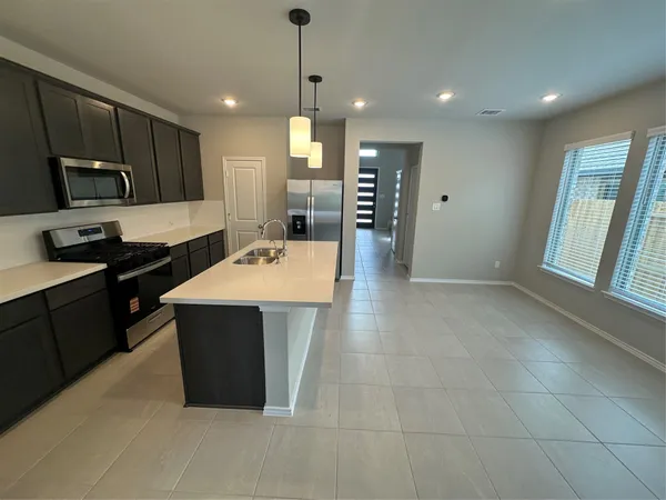 a kitchen with a sink a stove and refrigerator