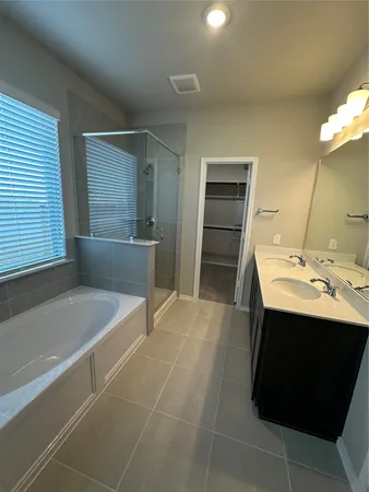 a bathroom with a bathtub and a shower