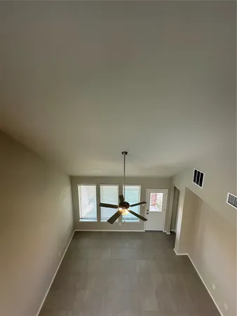 a view of a hallway with stairs and wooden floor