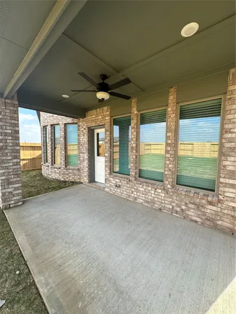 a view of an empty room with a fireplace and a large window