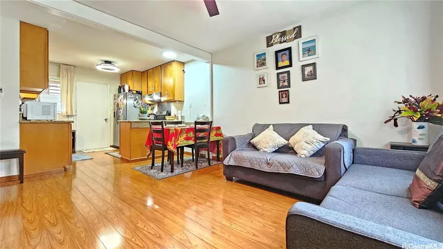 a living room with furniture and dining room