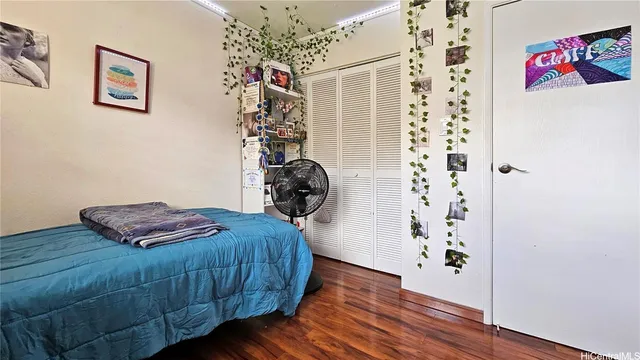 a bedroom with a bed and a dresser