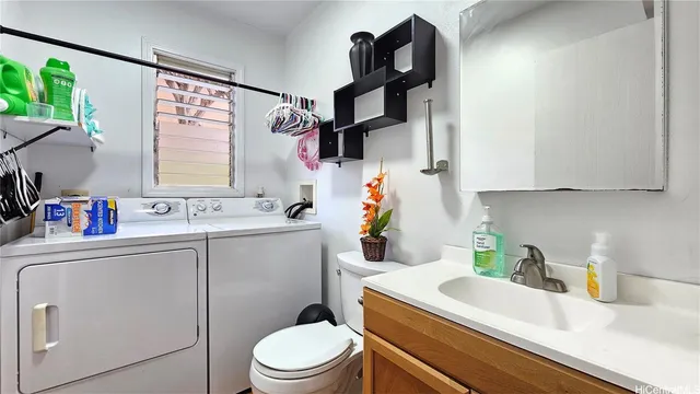 a bathroom with a sink a toilet and vanity