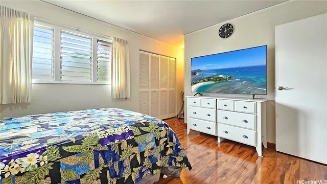 a bedroom with a bed and a dresser