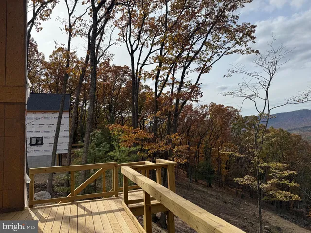 a view of a balcony with wooden fence and floor