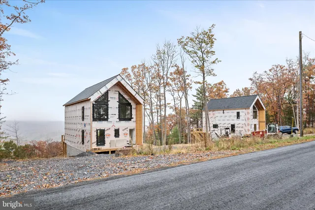 a view of a house with a yard covered in snow