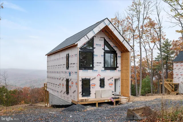 a view of house with a yard