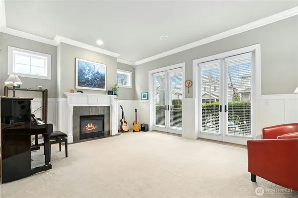 a living room with furniture a table and kitchen view