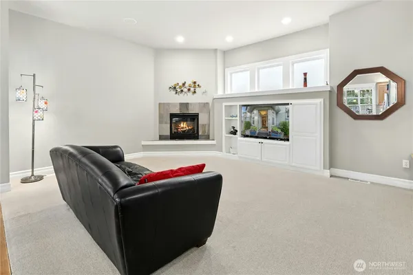 a living room with furniture window and a fireplace