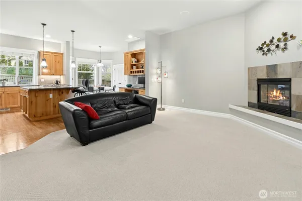 a kitchen with stainless steel appliances granite countertop a table chairs and granite counter tops