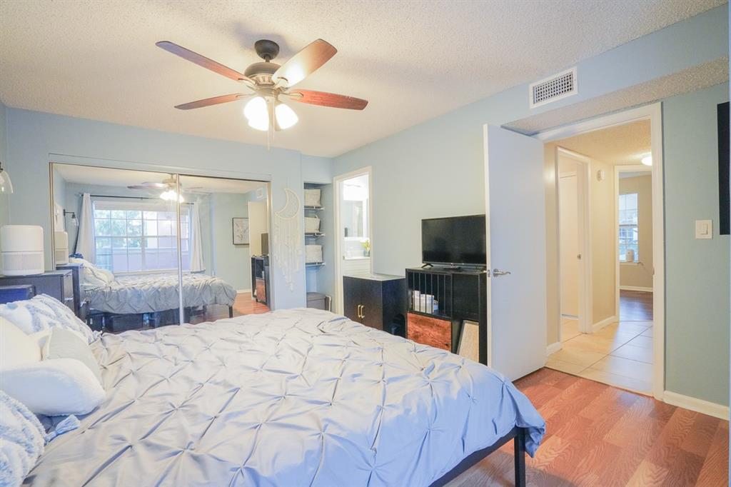 1011 Crystal Way, Unit P Delray Beach, FL 33444 - Photo 11 of 28 a bedroom with a large bed and a flat screen tv
