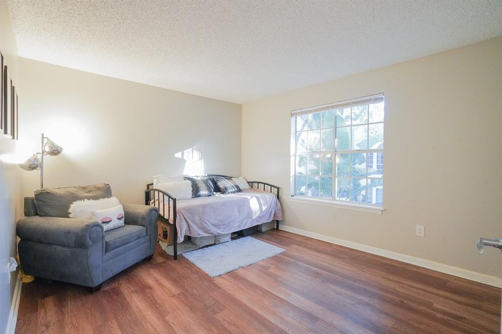 1011 Crystal Way, Unit P Delray Beach, FL 33444 - Photo 13 of 28 a bedroom with furniture and a wooden floor