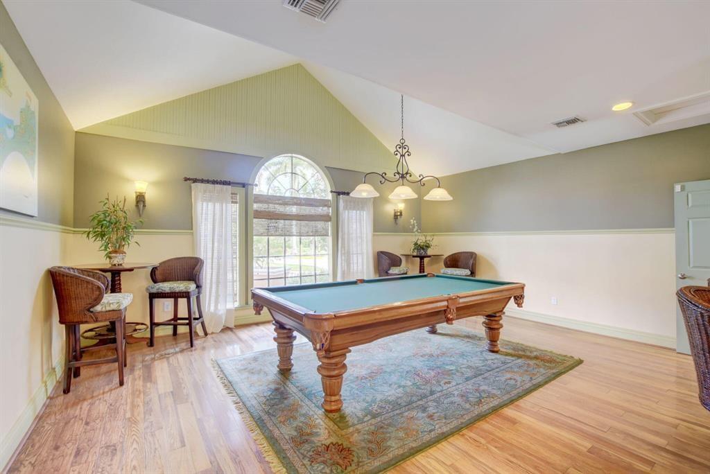 1011 Crystal Way, Unit P Delray Beach, FL 33444 - Photo 27 of 28 a room with pool table and wooden floor