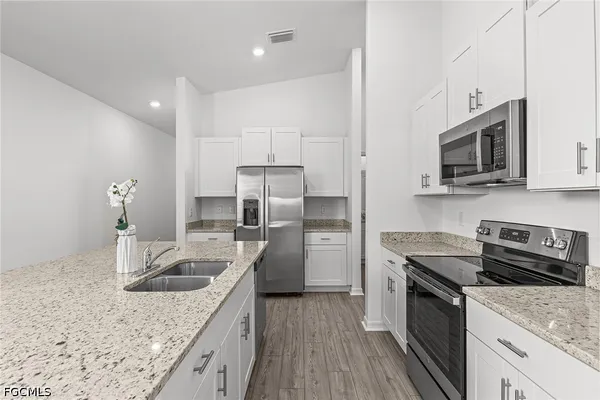 a kitchen with a sink stove and refrigerator