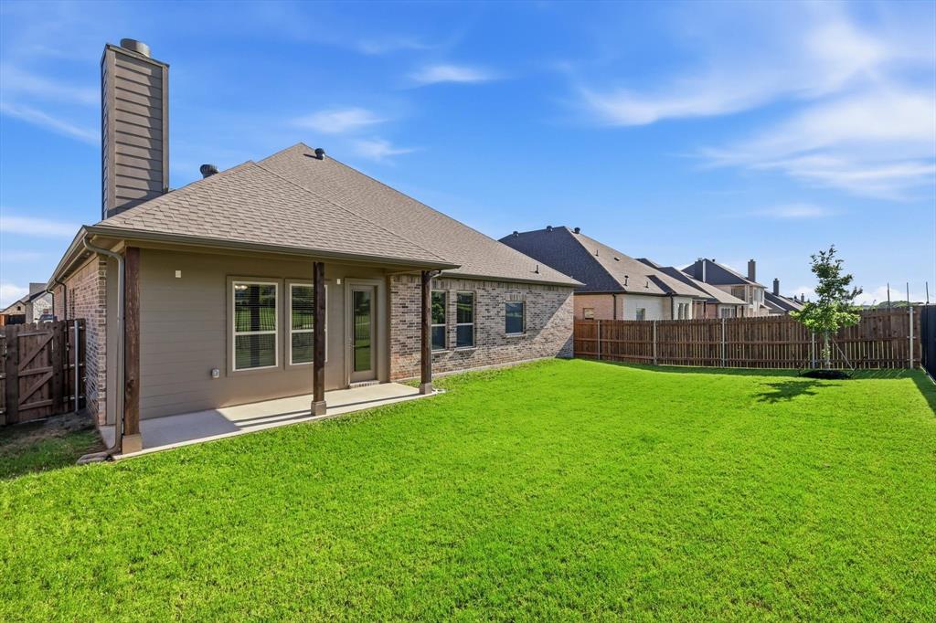 4017 Eagles Bluff Road Midlothian, TX 76065 - Photo 35 of 38 Expansive backyard featuring a covered patio with wood support beams, a freshly sodded lawn, and a full privacy fence