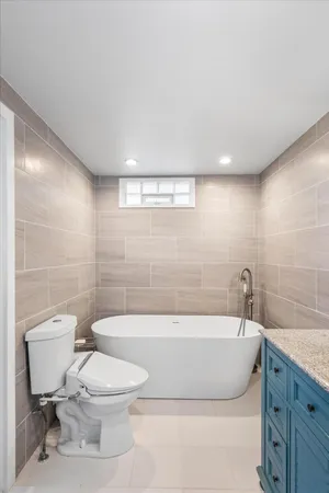 a bathroom with a bathtub and toilet