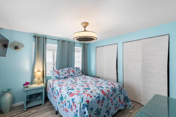 a bedroom with a bed and a chandelier