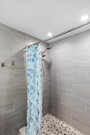 a bathroom with a shower and a sink