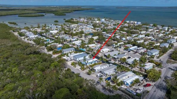 a aerial view of a house with swimming pool and lake view