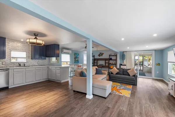 a living room with furniture and kitchen view