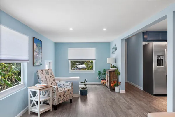 a bedroom with furniture and a wooden floor