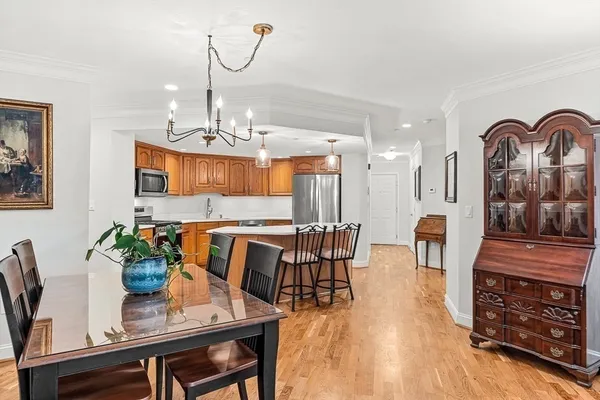 a view of a dining room with furniture a chandelier and wooden floor