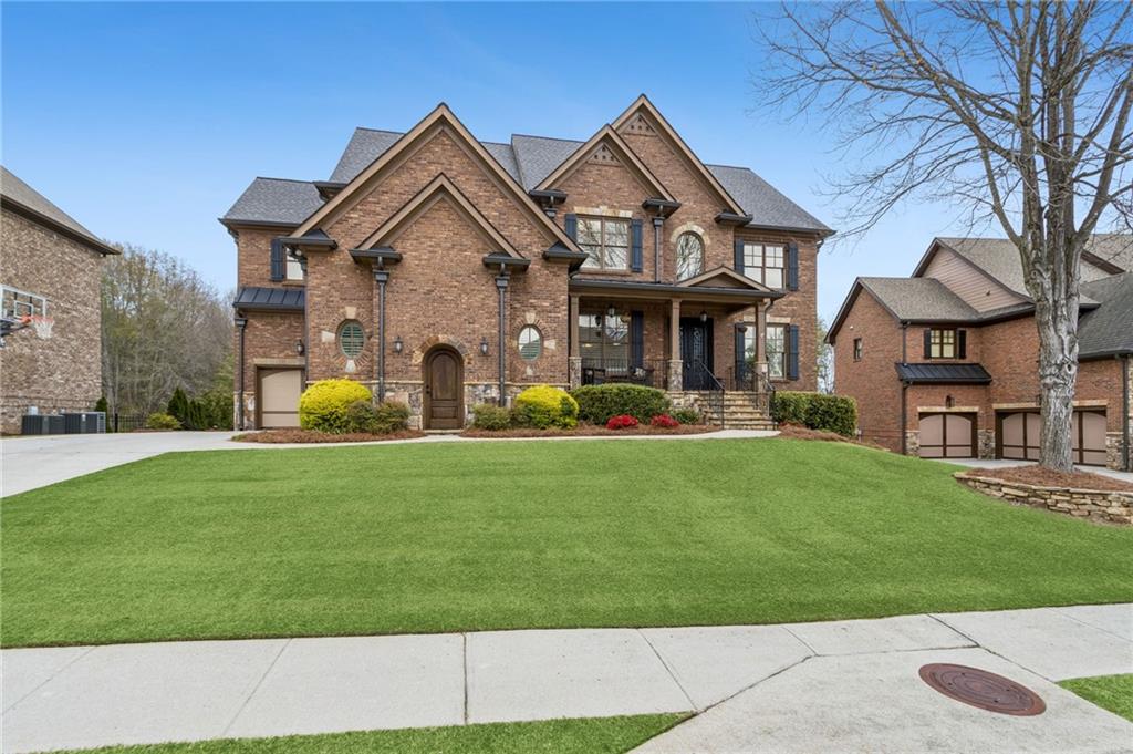 a front view of a house with a garden and plants