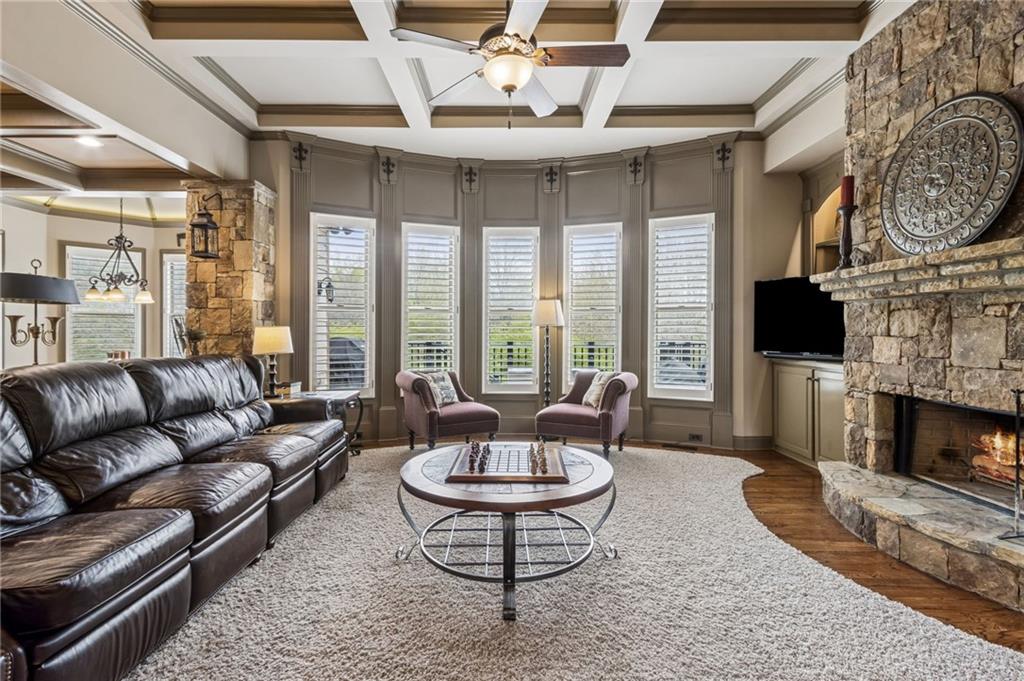 2391 Hopehaven Way Hoschton, GA 30548 - Photo 23 of 87 a living room with furniture a fireplace and a flat screen tv