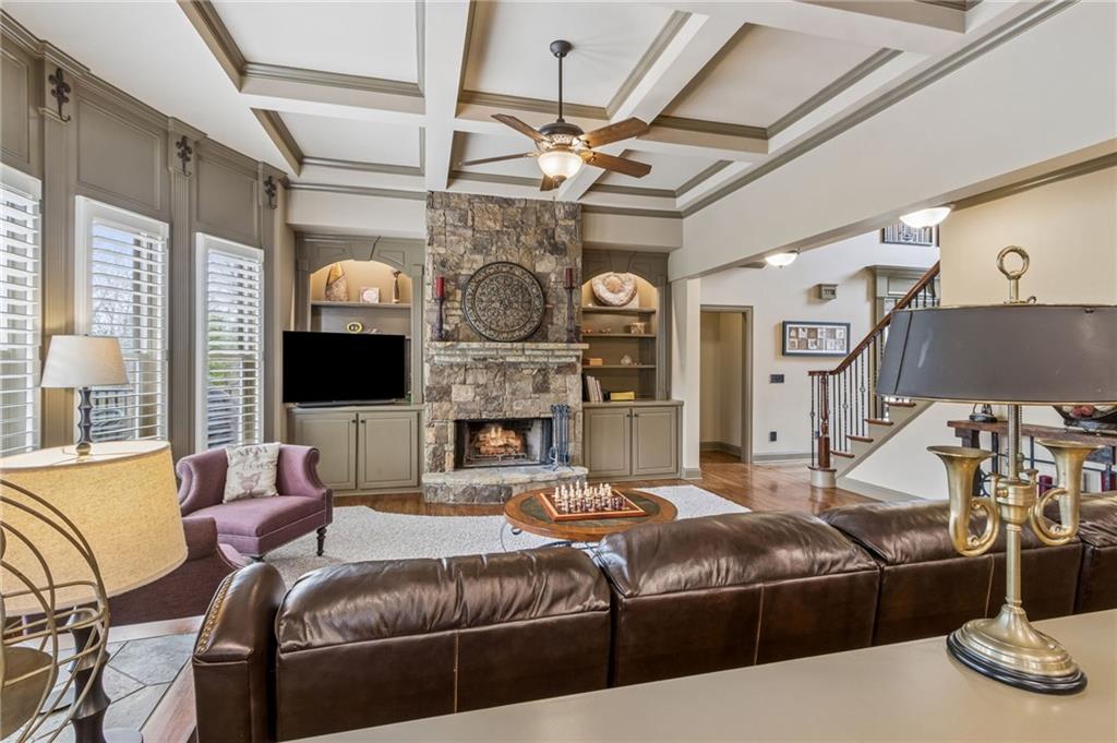 2391 Hopehaven Way Hoschton, GA 30548 - Photo 24 of 87 a living room with furniture a fireplace and a flat screen tv