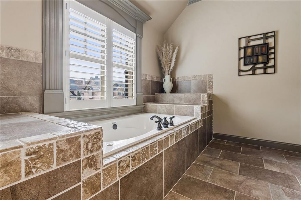2391 Hopehaven Way Hoschton, GA 30548 - Photo 42 of 87 a spacious bathroom with a tub a sink and a window