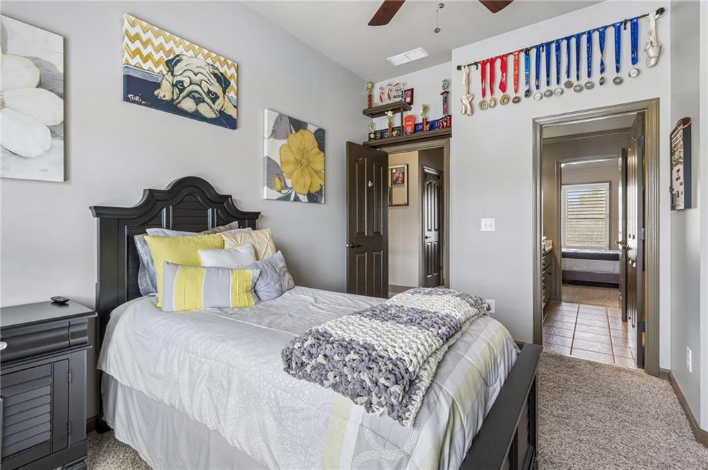 2391 Hopehaven Way Hoschton, GA 30548 - Photo 49 of 87 a bedroom with a bed and a chandelier