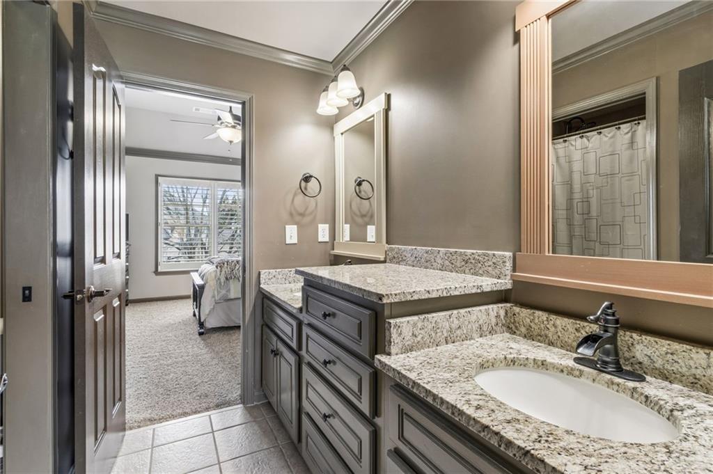 2391 Hopehaven Way Hoschton, GA 30548 - Photo 50 of 87 a bathroom with a granite countertop sink a mirror and a shower