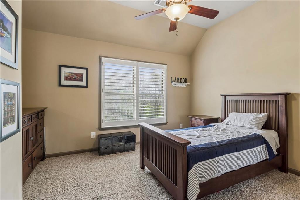 2391 Hopehaven Way Hoschton, GA 30548 - Photo 51 of 87 a bedroom with a bed and a chandelier