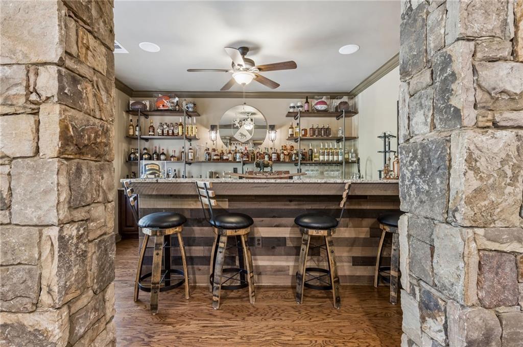2391 Hopehaven Way Hoschton, GA 30548 - Photo 66 of 87 a kitchen with stainless steel appliances kitchen island granite countertop a table and chairs in it