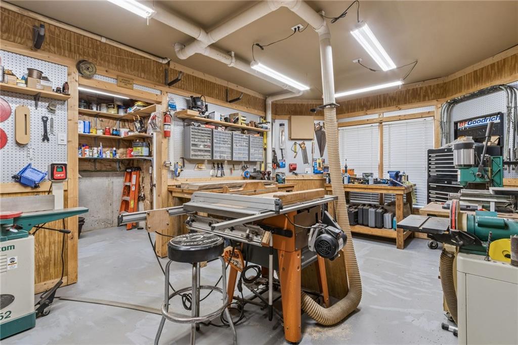 2391 Hopehaven Way Hoschton, GA 30548 - Photo 72 of 87 a gym room with lots of furniture and clutter