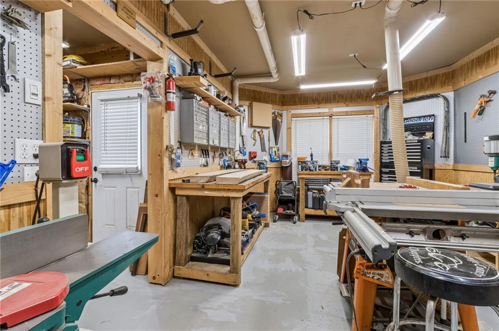 2391 Hopehaven Way Hoschton, GA 30548 - Photo 73 of 87 a utility room with stainless steel appliances kitchen island a table and chairs in it